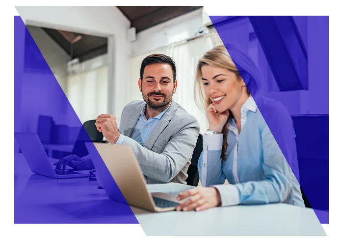 Accounting professionals collaborating around a laptop in an office