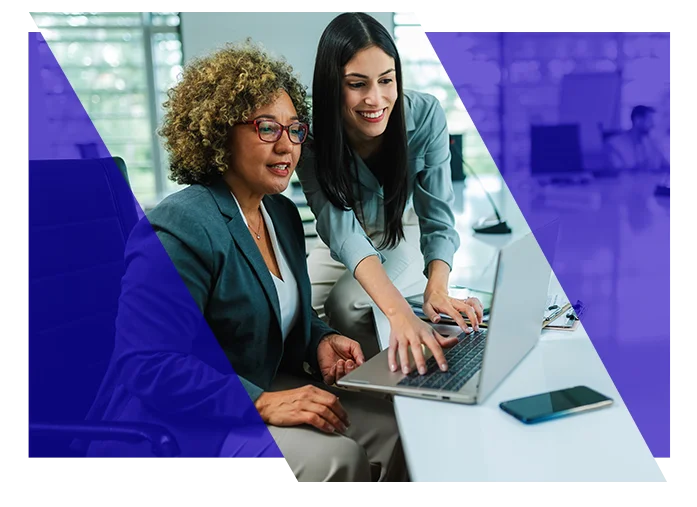 Accounting professionals reviewing information together on a laptop