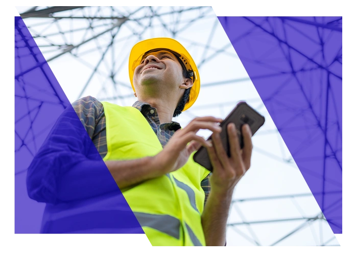Electrical contractor using a smartphone near power lines