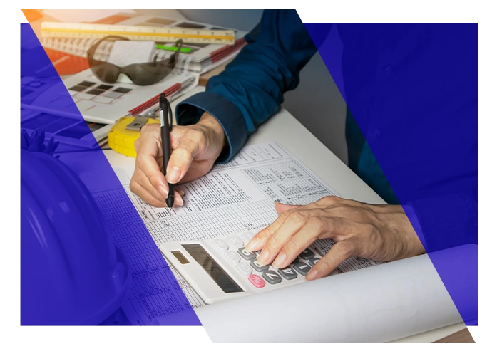 Contractor reviewing project costs with a calculator and paperwork