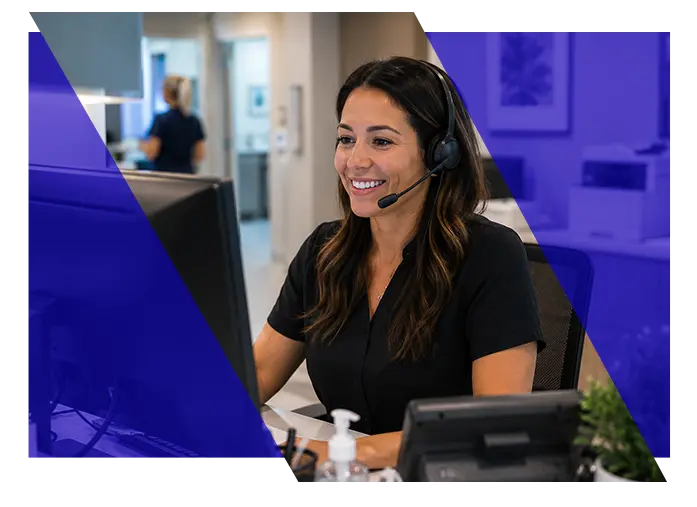 Healthcare office professional wearing a headset while working at a computer