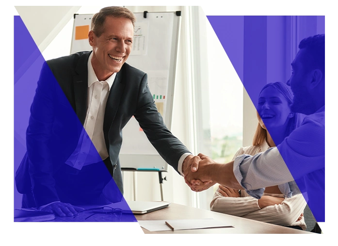 Business professionals shaking hands during an office meeting
