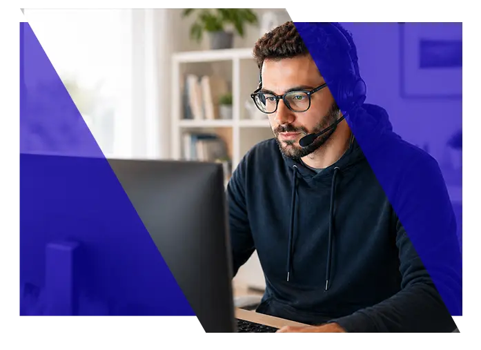 Technical support specialist wearing a headset while working at a computer