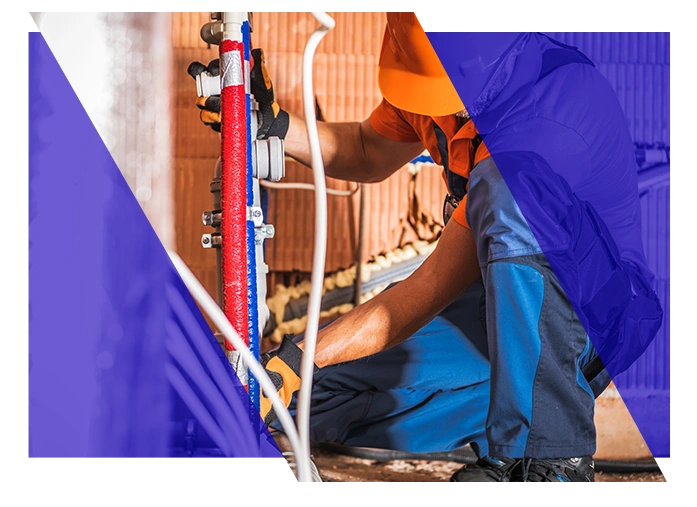 Plumbing contractor working on pipes at a job site