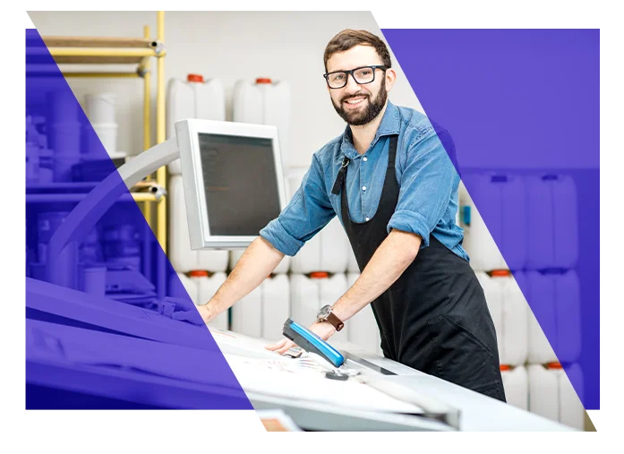 Print shop employee working at a commercial printing workstation