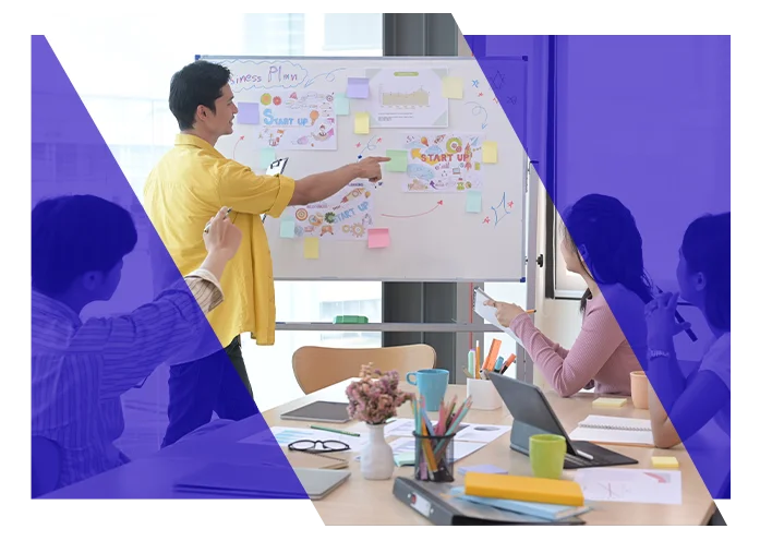Project manager presenting a project plan to colleagues at a whiteboard