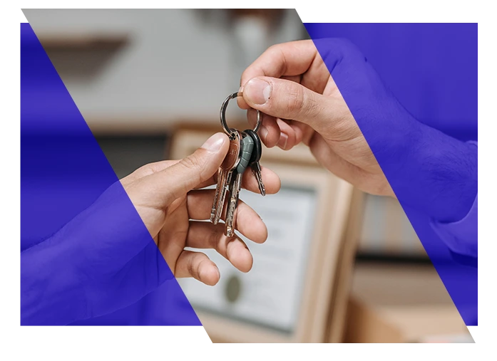 Person handing property keys to another person