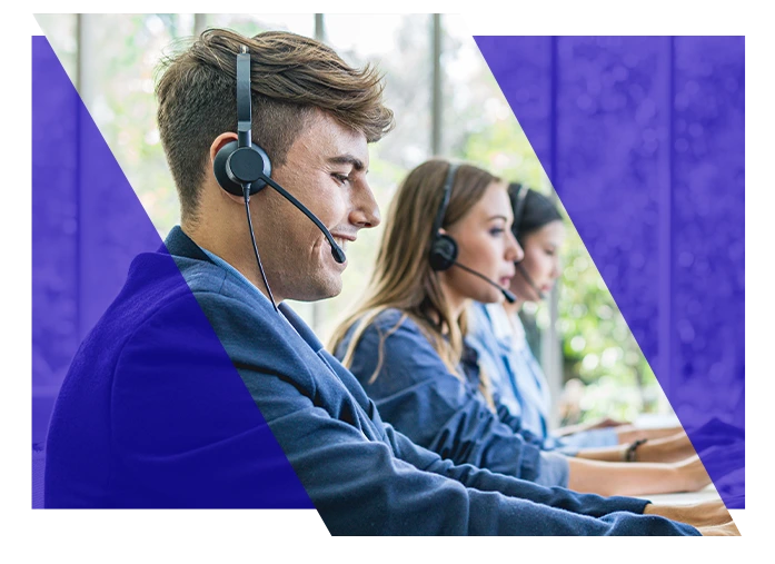 Technical support specialists wearing headsets while working at computers