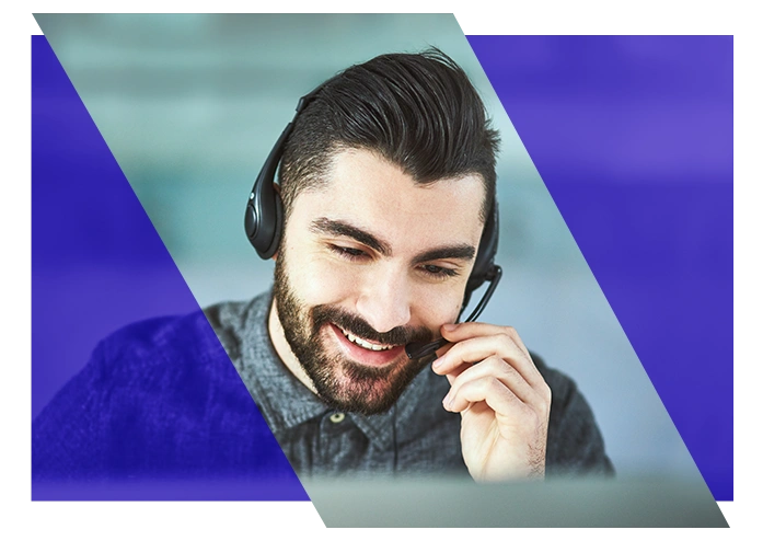 IT support specialist wearing a headset while working at a computer