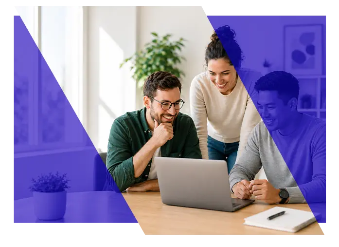 Business professionals collaborating around a laptop in an office