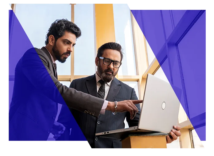 Business professionals reviewing information together on a laptop