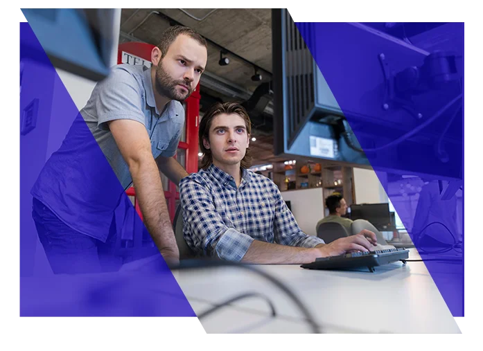 IT professionals reviewing information together on a computer screen