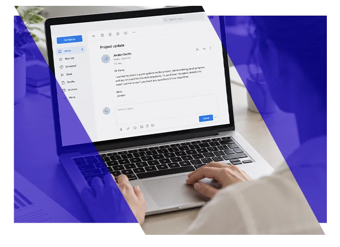 Employee composing an email on a laptop