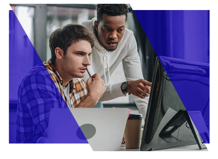 Coworkers reviewing information together on a computer