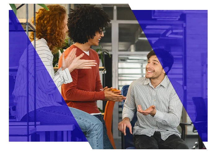 Coworkers discussing work together in an office