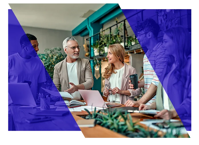 Business team collaborating around laptops during an office meeting