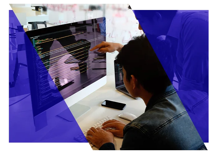 IT professionals reviewing information together on a computer screen