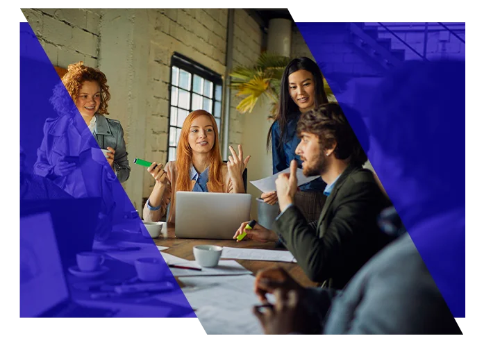 Business team collaborating around a laptop during an office meeting